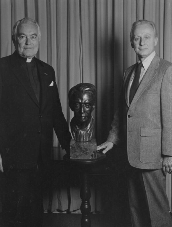Fr. Ted Hesburgh and Ralph McInerny standing with a bust of Jacques Maritain between them