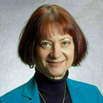 Jean Porter, wearing black turtle neck and blue jacket