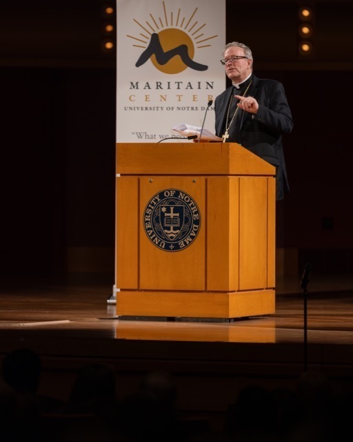 Man dressed in black at podium
