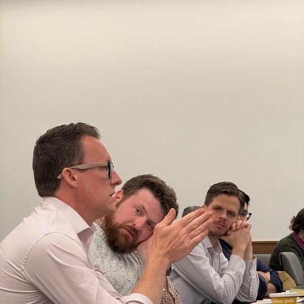 Audience members ask questions at academic conference